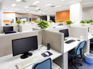 Executive private office with wooden panelling, built-in shelving, and a large desk in natural light
